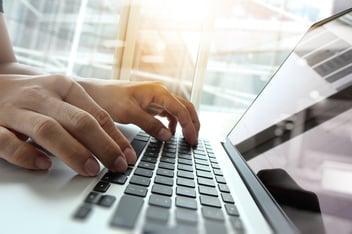 hands typing on a keyboard