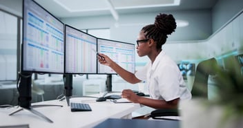 african american female dentist looking at billing codes on computer