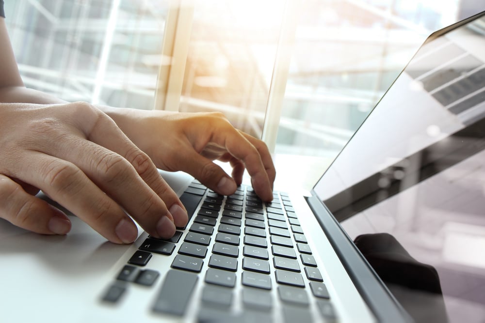 hands typing on a keyboard