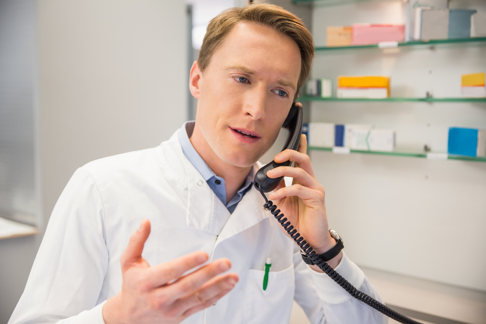 dentist in dental practice on the phone