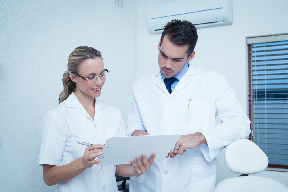 Two dentists reviewing reports together